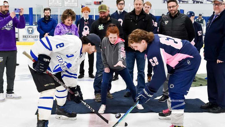 Marissa Carney, Penn State Altoona’s media and public relations coordinator and breast cancer survivor, performs the ceremonial puck drop.